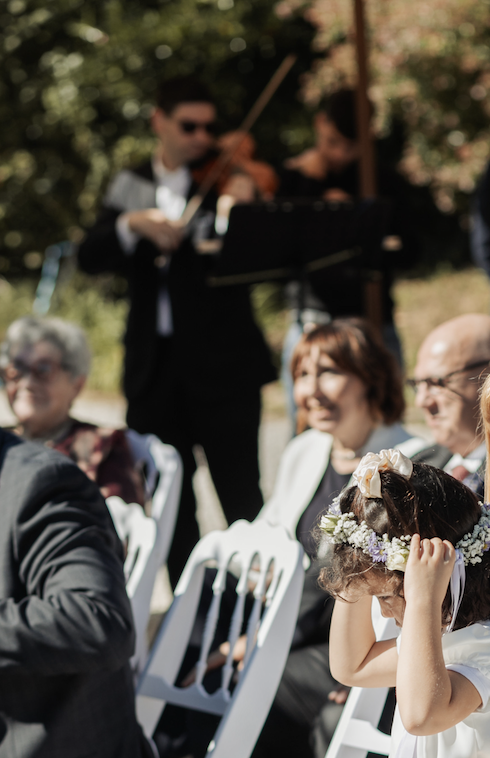 wedding music ensemble behind bride and groom's wedding ceremony guests.
